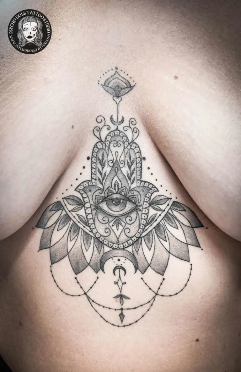 Hand of Fatima tattoo in the middle of the chest