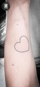 Fine line heart tattoo